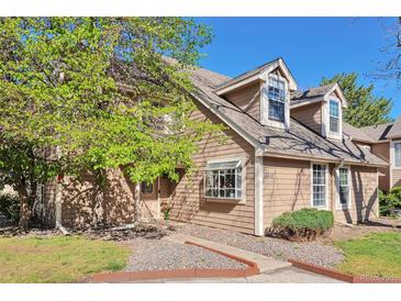 Charming home exterior boasts mature trees, fresh paint, and well-maintained landscaping on a sunny day at 13462 E Asbury Dr, Aurora, CO 80014