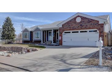 Charming single-Gathering home featuring a brick facade, two-car garage, and well-maintained landscaping at 7160 S Jellison St, Littleton, CO 80128