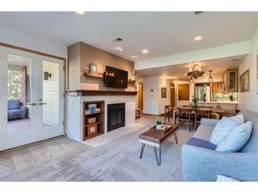 Bright living room with fireplace and access to balcony at 624 Pearl St # 301, Boulder, CO 80302