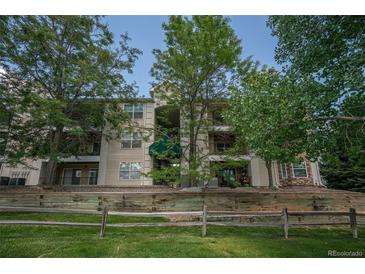 Inviting condo building with mature trees and meticulously maintained landscaping at 12208 W Dorado Pl # 207, Littleton, CO 80127