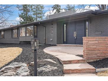 Stylish gray brick home featuring a modern double door entry, and landscaped front yard at 456 Cherry St, Denver, CO 80220