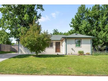 Charming single-story home featuring a well-maintained lawn and mature trees at 5167 S Pearl St, Littleton, CO 80121