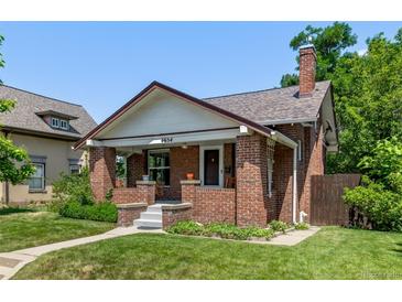 Charming brick home with a well-maintained front yard and a welcoming front porch with steps leading to the entrance at 4654 Bryant St, Denver, CO 80211