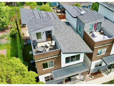 Modern townhome showcases a private rooftop deck with outdoor seating for entertaining and relaxation at 4035 Fenton Ct, Wheat Ridge, CO 80212