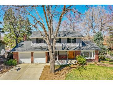 Charming two-story home with brick accents, well-manicured lawn, and a two car garage in a quiet neighborhood at 12423 W 68Th Ave, Arvada, CO 80004