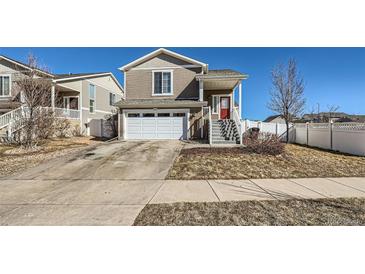 Two-story home features an attached two-car garage and landscaped front yard at 5534 Killarney St, Denver, CO 80249