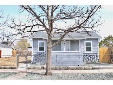 Charming grey home with a stone foundation, well-maintained lawn, and welcoming curb appeal at 4460 Columbine St, Denver, CO 80216