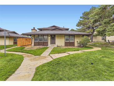 Charming home with a well-maintained front yard, a cozy exterior, and a welcoming pathway at 3827 S Fraser St, Aurora, CO 80014
