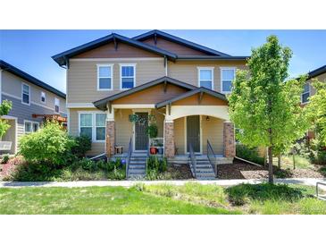 Charming townhome featuring a welcoming front porch and manicured landscaping in a desirable neighborhood at 3450 Valentia St, Denver, CO 80238