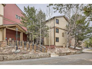 Exterior view of home with wood siding and a landscaped entrance at 325 Four O Clock Rd # 303, Breckenridge, CO 80424