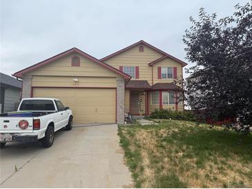 Two-story home with a two-car garage and a well-maintained lawn at 14874 E 52Nd Ave, Denver, CO 80239