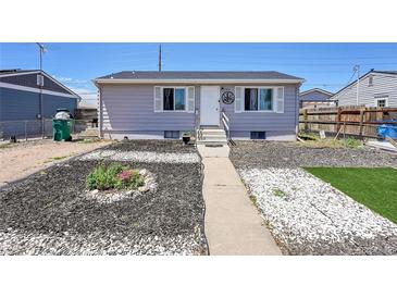 Charming single-story home with a neatly landscaped front yard and inviting entrance at 7831 Hollywood St, Commerce City, CO 80022