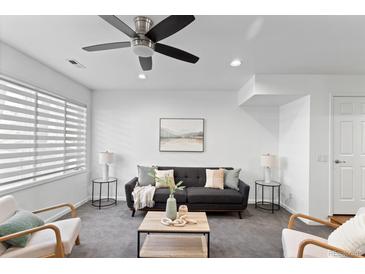 Relaxing living room offers a comfortable sofa and inviting natural light through the window at 152 S Jackson St, Denver, CO 80209