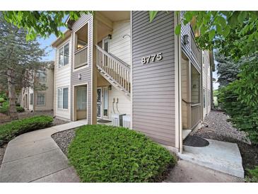 Attractive two-story condo featuring well-manicured landscaping, inviting entryway, and visible unit number at 8775 W Berry Ave # 203, Littleton, CO 80123
