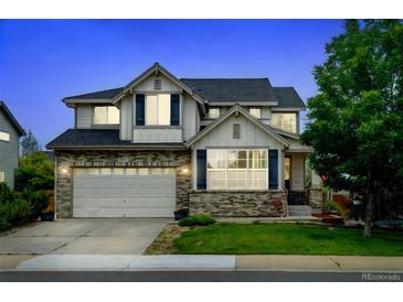Charming two-story home with brick accents, well-manicured lawn, and an attached two-car garage at 1995 E 166Th Ave, Thornton, CO 80602