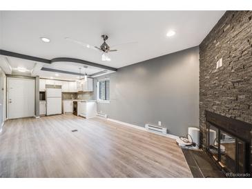 Bright living room with fireplace and laminate flooring at 14852 E Kentucky Dr # 928, Aurora, CO 80012