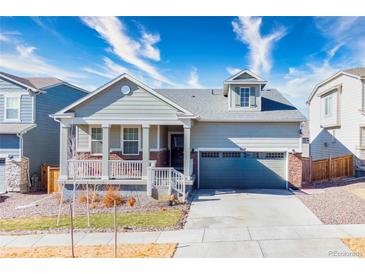 Charming home features a quaint porch and well-maintained front yard, creating a welcoming curb appeal at 9227 Salida St, Commerce City, CO 80022