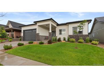 Charming single-story home features a well-manicured lawn and stone accents at 2794 Heron Lakes Pkwy, Berthoud, CO 80513