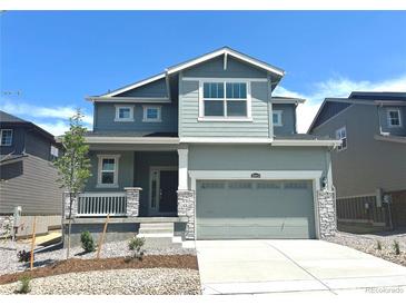Charming two-story home with a two-car garage, stone accents, and a covered front porch at 10984 Snowdon St, Parker, CO 80134