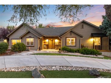 Charming single-story home featuring professional landscaping, decorative rock and inviting curb appeal at 1392 W Caley Ave, Littleton, CO 80120