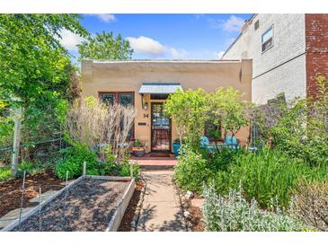 Charming home featuring a well-maintained front yard with garden beds and a cozy entrance at 34 W Maple Ave, Denver, CO 80223