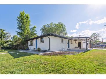 Charming single story home featuring a well maintained lawn and covered car port at 6193 Holland St, Arvada, CO 80004