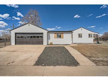 Cozy home with garage and welcoming landscaping and hardscape at 851 S Umatilla Way, Denver, CO 80223