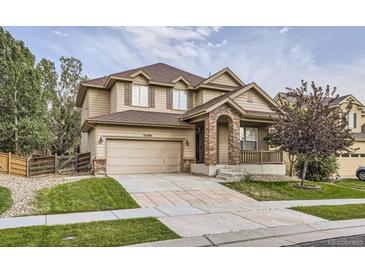 Charming two-story home with a two car garage and a well-manicured lawn at 10288 Salida St, Commerce City, CO 80022