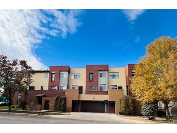 Modern townhome with a blend of brick and stucco exterior, offering a two-car garage and tidy landscaping at 500 30Th St # 5, Denver, CO 80205