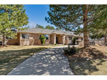 Beautiful brick home with mature trees and a long, private driveway at 3860 S Elkhart St, Aurora, CO 80014