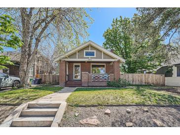 Charming brick bungalow with a welcoming front porch and well-maintained lawn at 2836 Cherry St, Denver, CO 80207