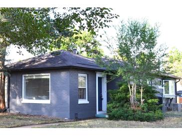 Charming single-story home with a brick exterior, well-maintained landscaping, and a welcoming entrance at 1300 Spruce St, Denver, CO 80220