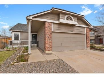 Charming single-Gathering home displaying an attached garage with brick and beige wood-look siding at 3844 S Gibralter St, Aurora, CO 80013