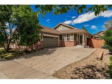Charming single-Gathering home with a well-maintained lawn, a two-car garage, and lovely brick accents at 16257 E 105Th Cir, Commerce City, CO 80022