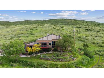 Charming home nestled into hillside with beautiful trees and landscaping at 2605 Cactus Cir, Golden, CO 80401