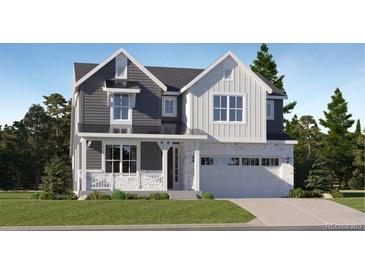 Charming two-story home with a blend of modern and classic architectural details and a well manicured lawn at 556 Nightsky St, Erie, CO 80516