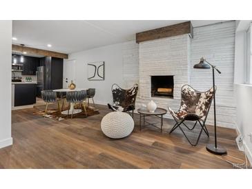 Bright living room features a modern fireplace and stylish seating arrangement perfect for relaxation at 11842 W 14Th Ave, Lakewood, CO 80401