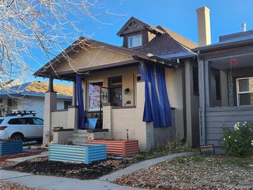 Charming craftsman bungalow with a welcoming front porch and well-maintained landscaping at 1536 Lowell Blvd, Denver, CO 80204