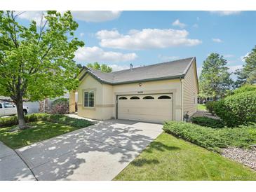 Charming single-Gathering home with an attached garage, mature tree, and well-manicured lawn at 2420 E 127Th Ave, Thornton, CO 80241