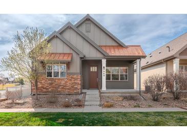 Charming home featuring a blend of modern design and natural textures with a copper roof and stone accents at 869 Bluestem Ln, Louisville, CO 80027