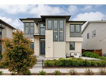 Stunning modern two-story home with stone accents, stylish windows, and a beautifully landscaped front yard at 5831 Galena St, Denver, CO 80238