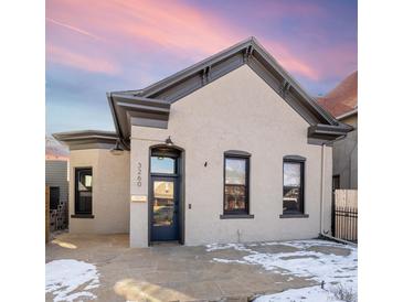 Renovated craftsman home with a charming facade and stone walkway at 3260 Curtis St, Denver, CO 80205