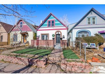 Charming home featuring vibrant trim, a brick foundation, and a well-manicured front yard at 69 W Cedar Ave, Denver, CO 80223