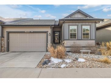 Charming home featuring a well-manicured front yard and an attached garage at 11884 Barrentine Loop, Parker, CO 80138