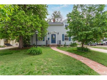 Charming home featuring a lush front yard and a welcoming stone walkway leading to the front door at 134 S 5Th Ave, Brighton, CO 80601
