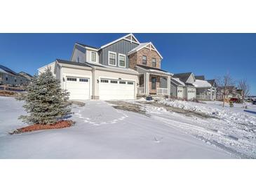Two-story house with stone and siding, three-car garage, and snowy front yard at 1143 Williams Loop, Elizabeth, CO 80107