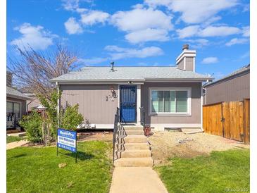Charming single-story home with a blue front door, concrete steps, and well-maintained front lawn at 3782 S Genoa Cir # A, Aurora, CO 80013