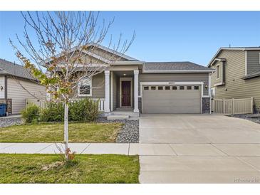 Charming single-Gathering home featuring a two-car garage and well-maintained front yard at 10555 Boston St, Commerce City, CO 80640