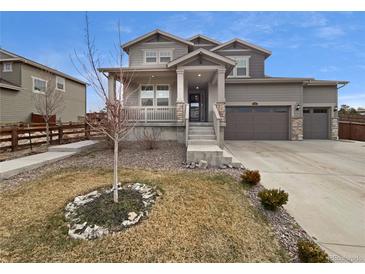 Charming two-story home with a well-maintained front yard, porch, and attached two-car garage at 950 Avena Ct, Elizabeth, CO 80107