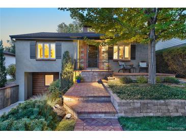 Charming home featuring inviting front porch, lush landscaping, and brick walkway at 1250 S Josephine St, Denver, CO 80210